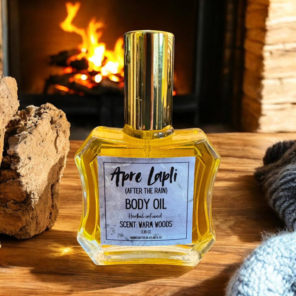 Body oil bottle labeled 'Apre Lapli' on a wooden surface with a fireplace in the background