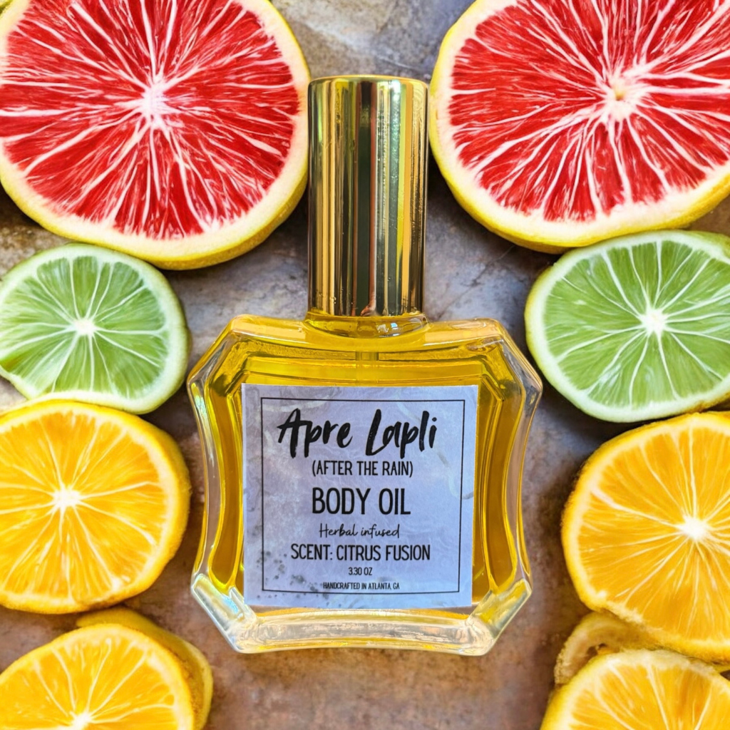 Body oil bottle labeled 'Apre Lapli' surrounded by sliced citrus fruits on a metallic surface