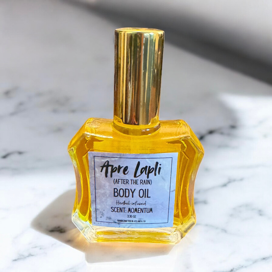 Body oil bottle with gold cap on a marble surface