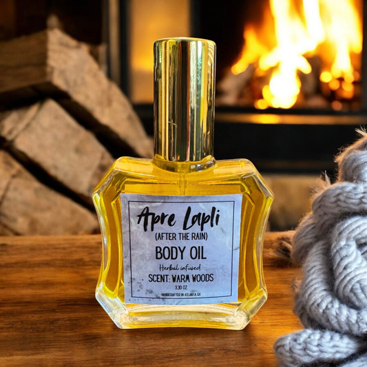 Body oil bottle labeled 'Apre Lapli' on a wooden surface with a fireplace in the background